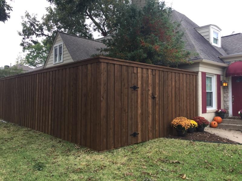 A picture of the brown color fencing beside the house